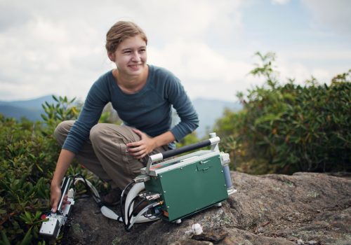 Student on a mountain doing research